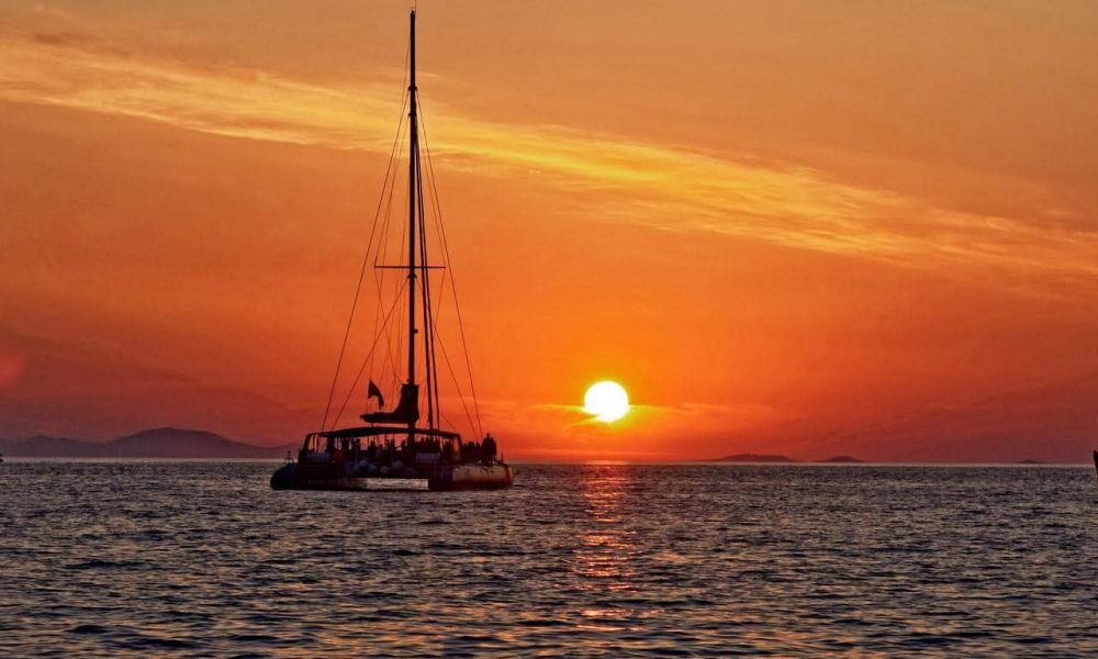 A sunset over sea is the main reason for choosing the best santorini sunset cruise by Spiridakos