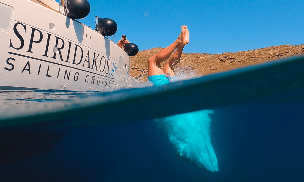 Diving into the crystal clear waters is one of the quintessential Santorini activities to do while on a sailing cruise.