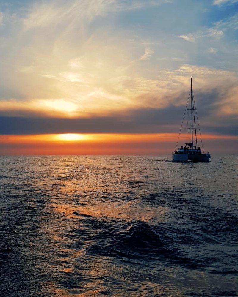 Amazing sunset at sea on board Spiridakos Sailing sunset dinner cruise santorini island
