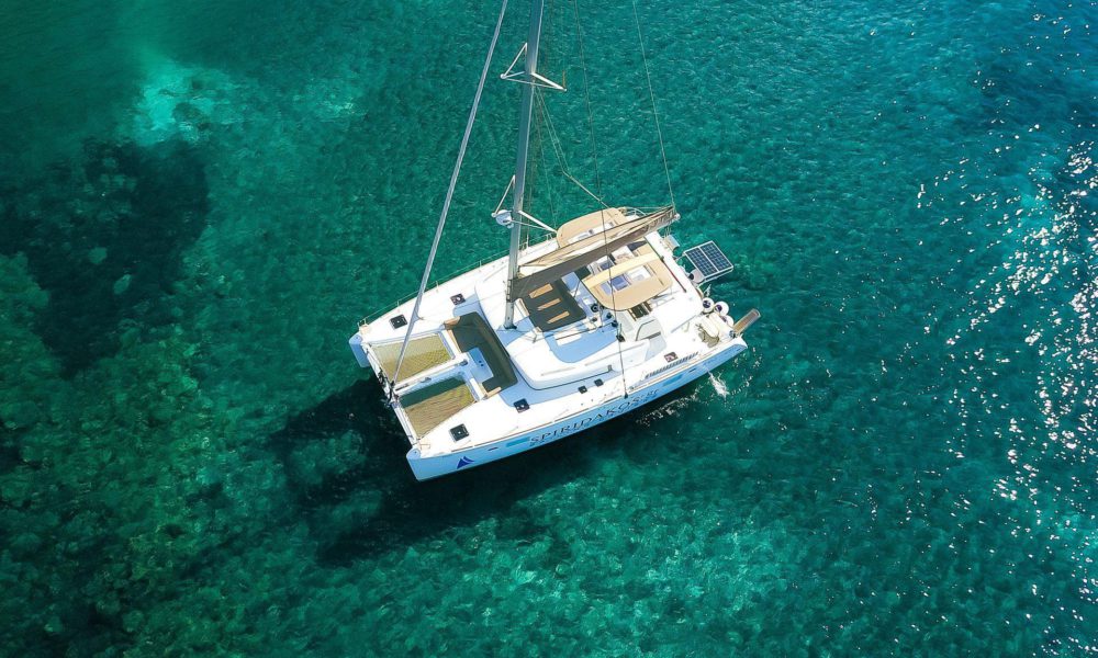 Aerial view of catamaran vessel by Spiridakos Sailing tours in Santorini.