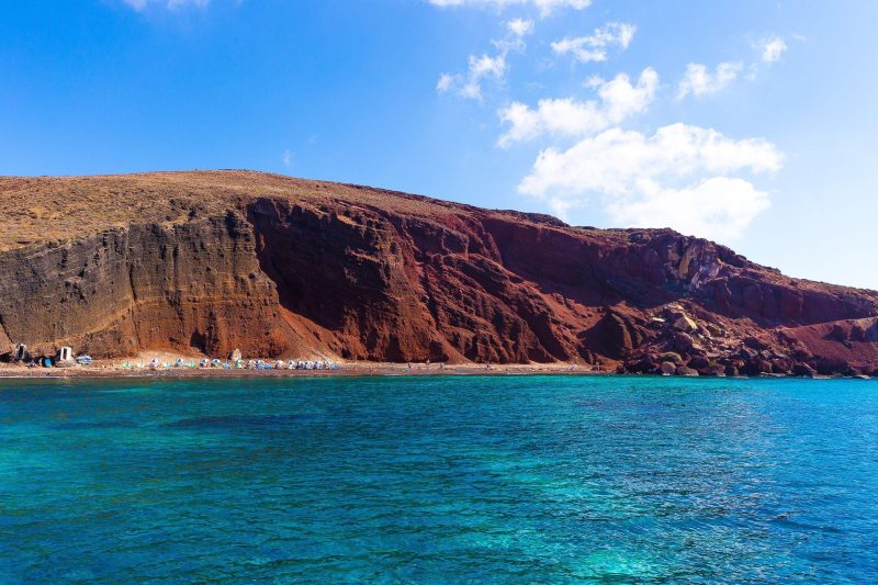 The famous Red Beach as seen from a Santorini Greece cruise with Spiridakos Sailing Cruises. Explore the island from a unique vantage point, away from the crowds.